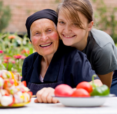 elderly woman and her careteker smiling